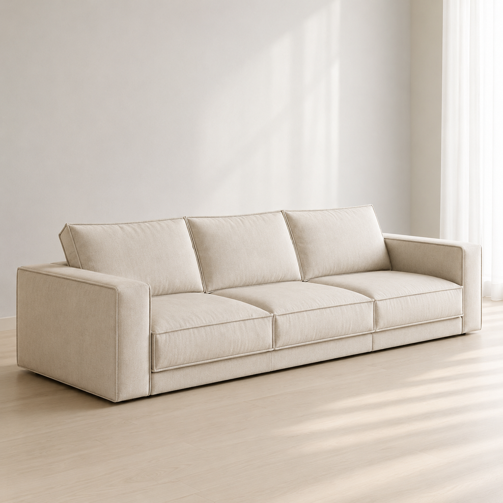 Ample Sofa in cream, three loose cushions between two upright block arms