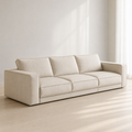 Ample Sofa in cream, three loose cushions between two upright block arms