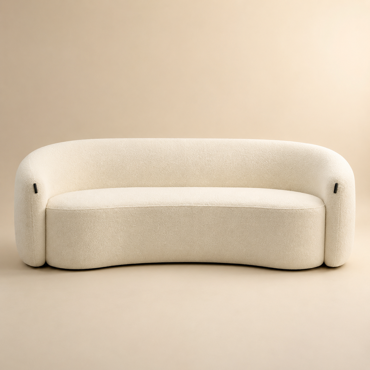 Anse Sofa in cream bouclé seen straight on, the barrel back wrapping from arm to arm