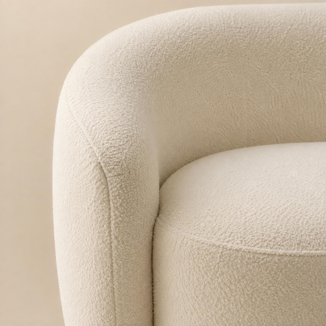 Close view of the Anse Sofa, the bouclé loop where the back curves down to meet the seat