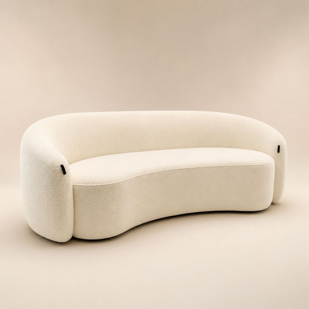 Anse Sofa at an angle, the kidney shape of the seat reading against the base