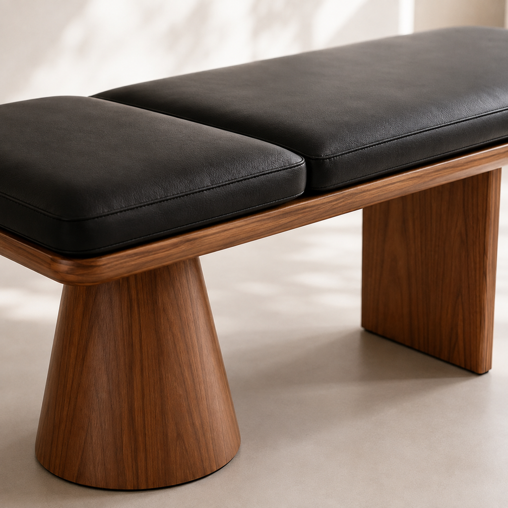 Close view of the black pads seated in the rounded walnut tray above the conical pedestal