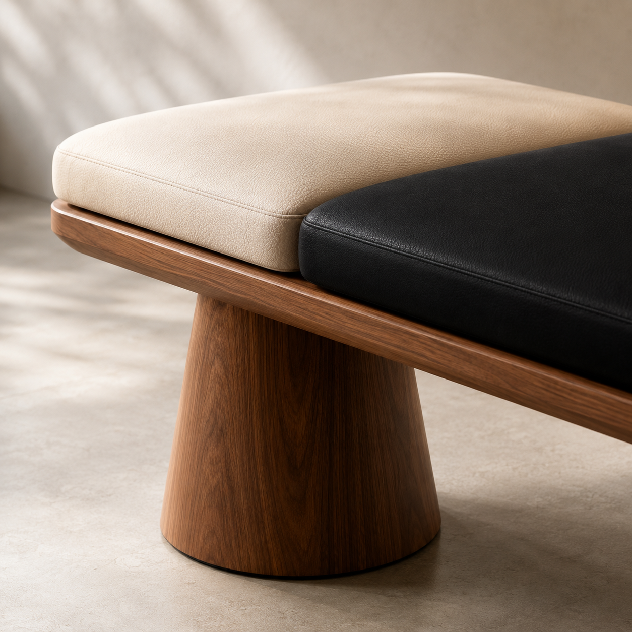 The cream pad and the black pad seen close, showing the seam and the rounded walnut edge