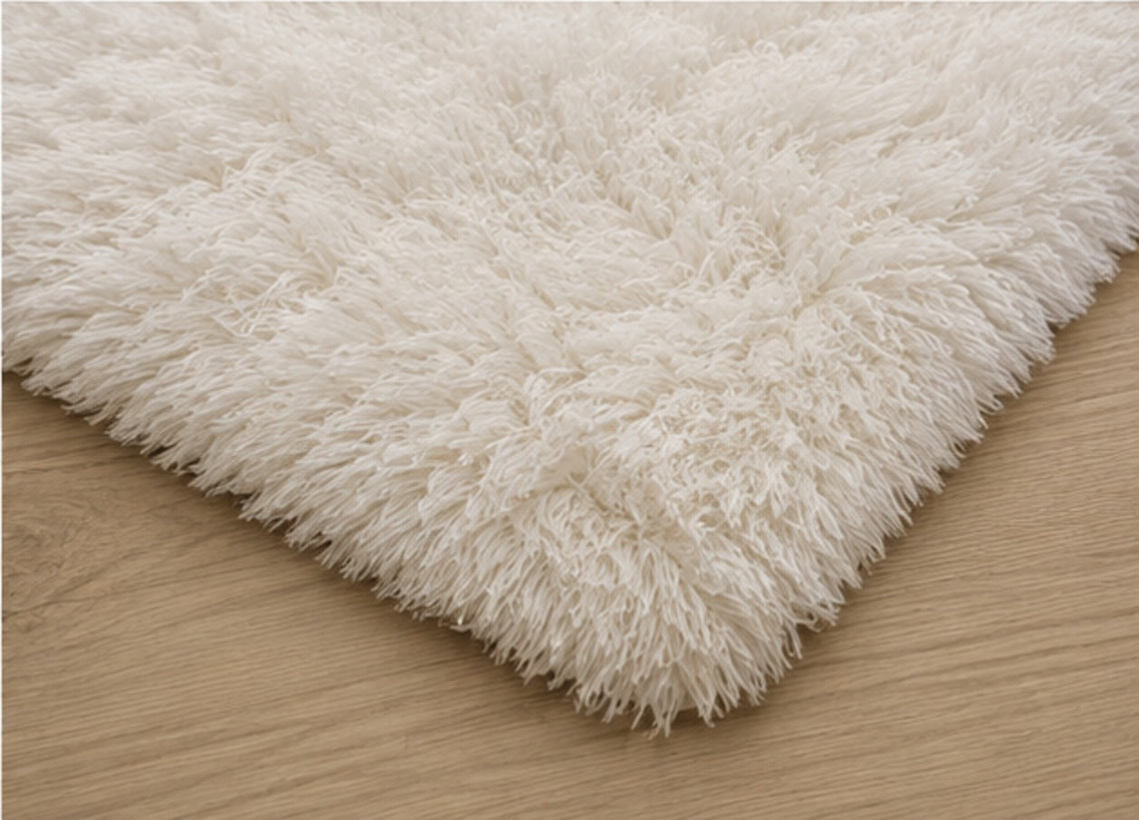 The corner of the Aveline Plush Rug, showing the depth of the pile against the floor