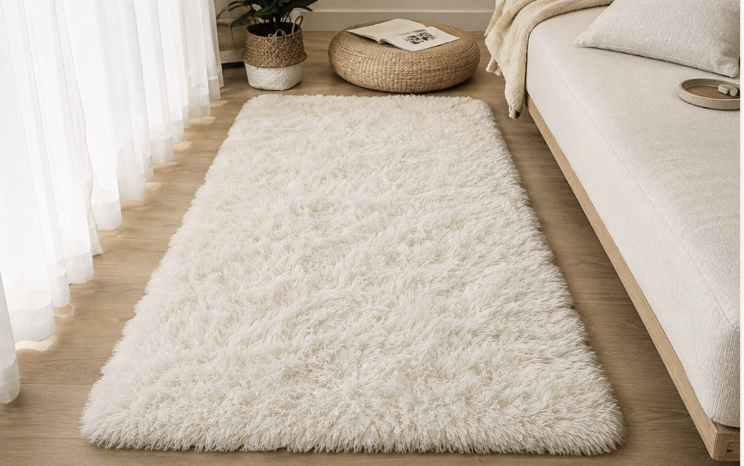Aveline Plush Rug laid out next to a low sofa, seen from the side