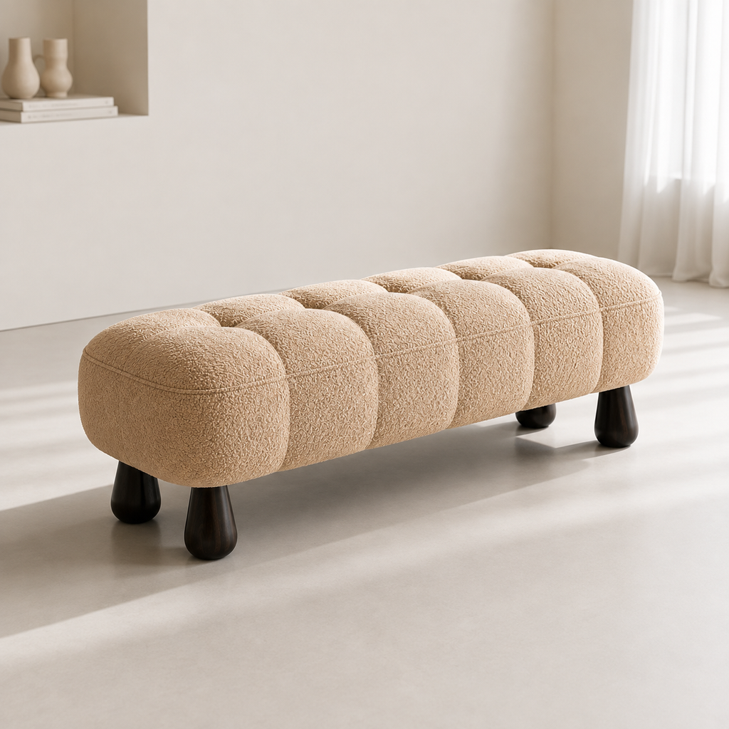 Capiton Bench in camel boucle, grid-tufted, on four dark turned teardrop legs in a pale room