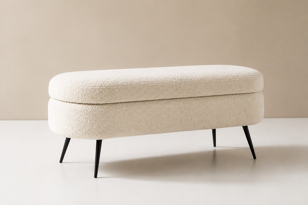 Cocon Bench in cream bouclé, a rounded oval seat on four slim black tapered legs