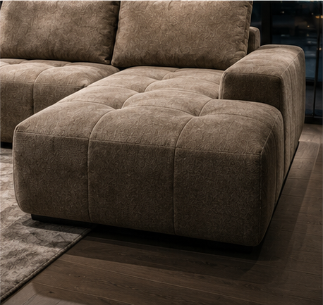 The open chaise of the Damier Sofa, tufted in the same grid as the rest of the seat