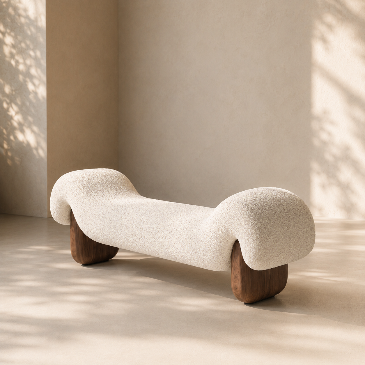 Dune Bench in cream bouclé, the undulating seat resting on two rounded walnut blocks