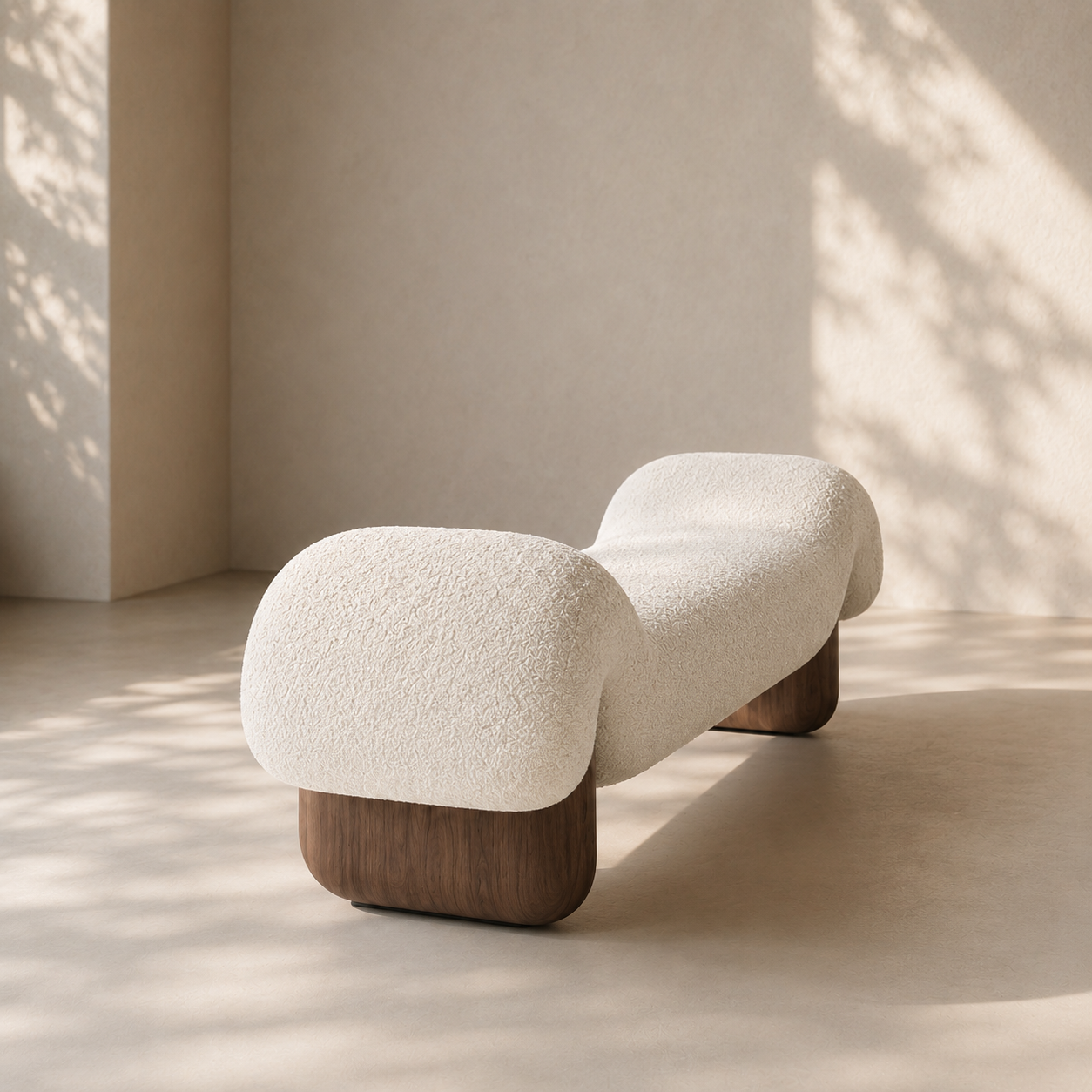 Dune Bench from the end, showing the rolled bouclé volume and the rounded walnut block