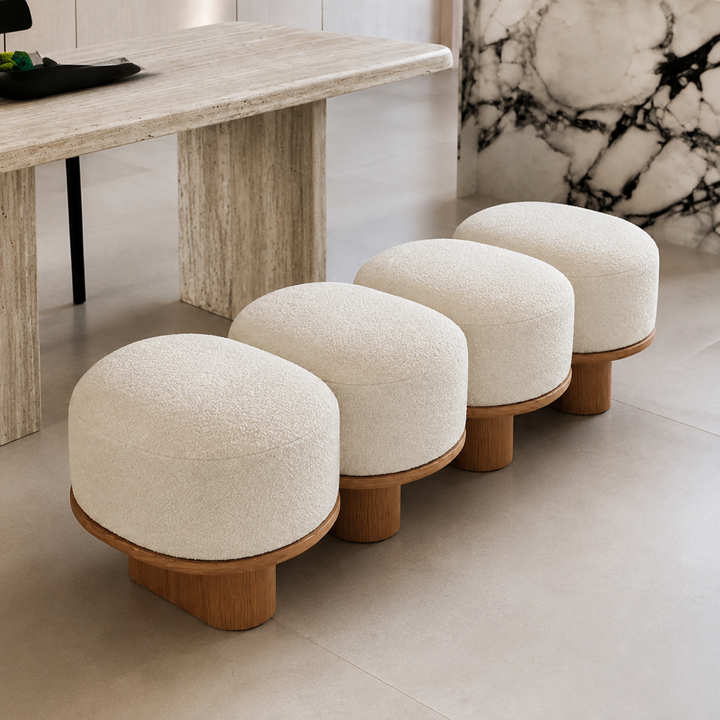 Galet Bench in cream boucle beside a travertine dining table