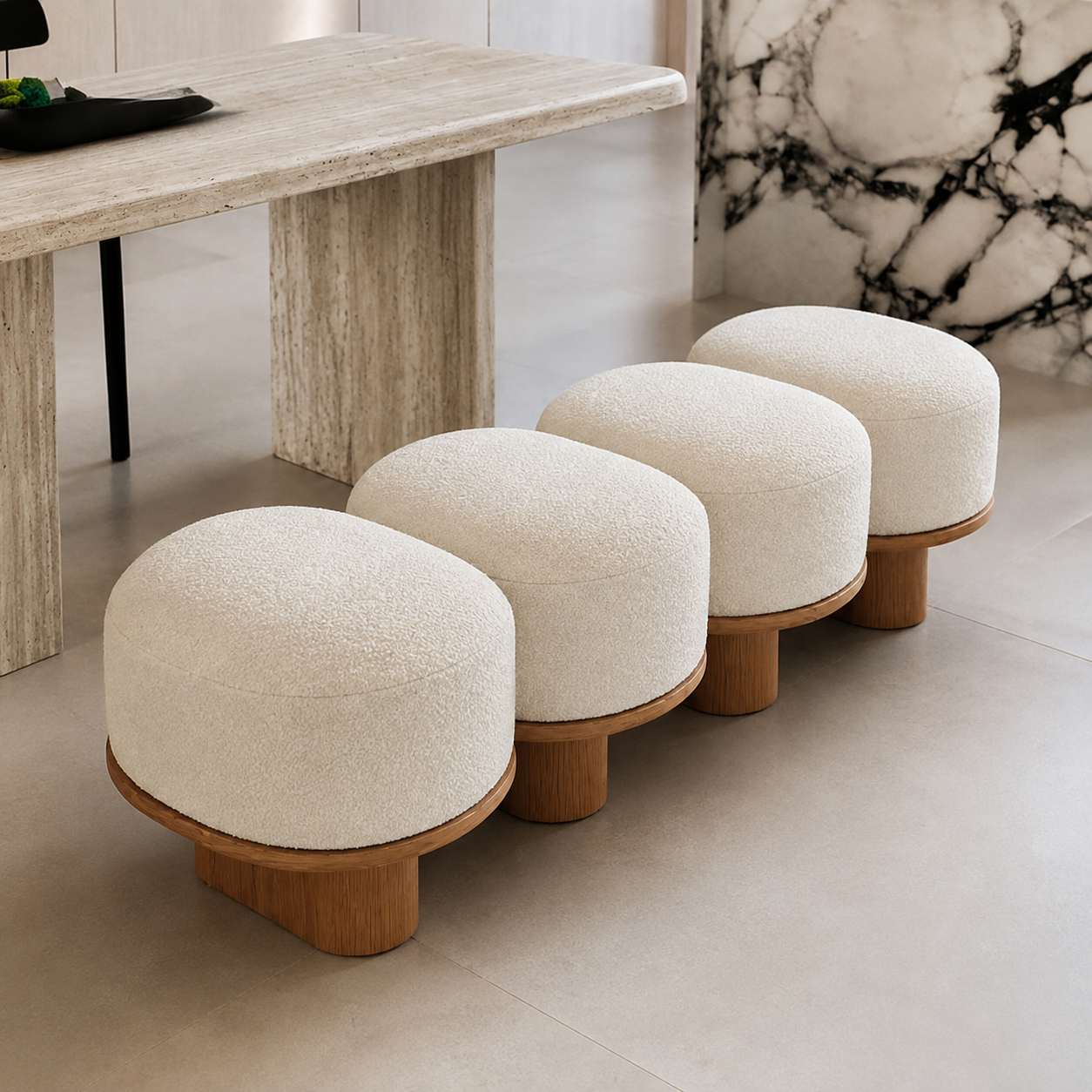 Galet Bench in cream boucle beside a travertine dining table