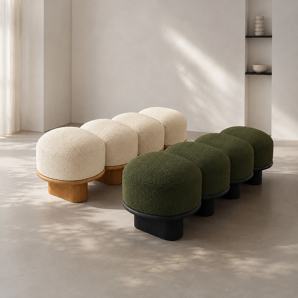 The Galet Bench in cream on oak and in forest on black, side by side in a bright room