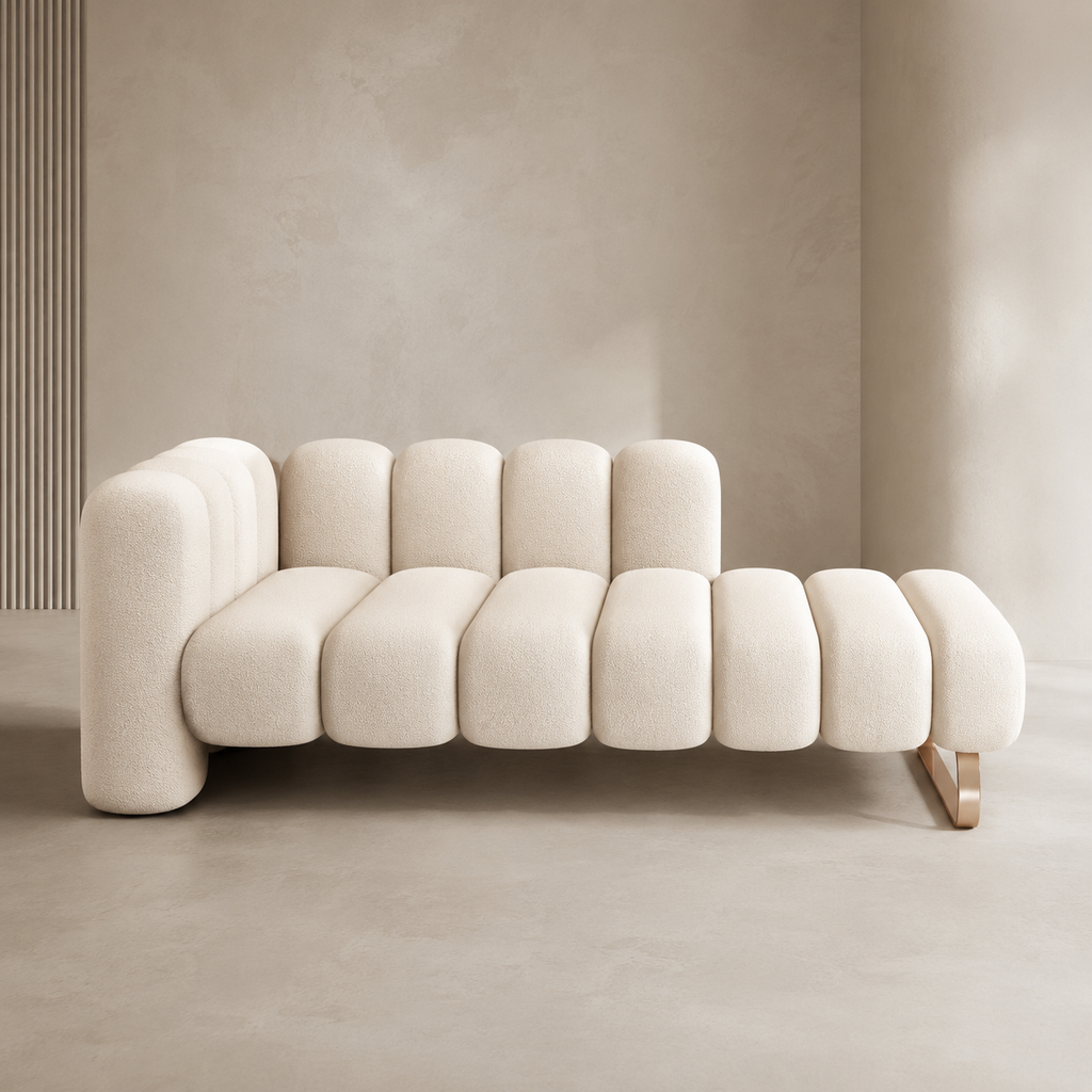 Godron Bench in cream bouclé, the fluted seat running from a low backrest to an open end on a brass-toned rail