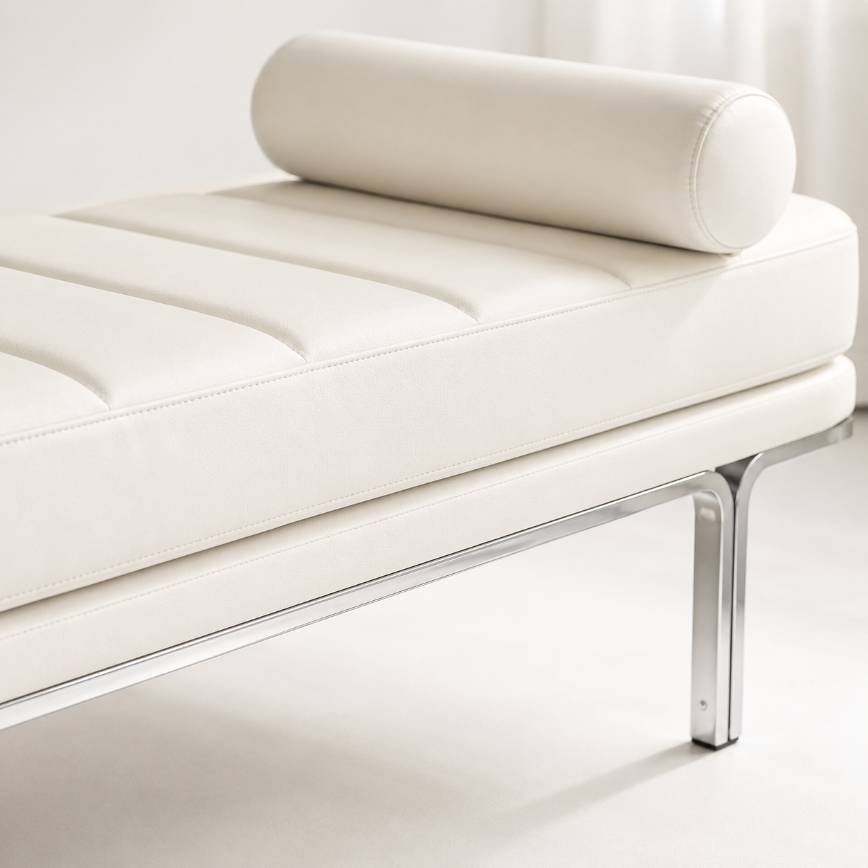 Close view of the channelled seam lines, the bolster and the polished steel leg meeting the frame