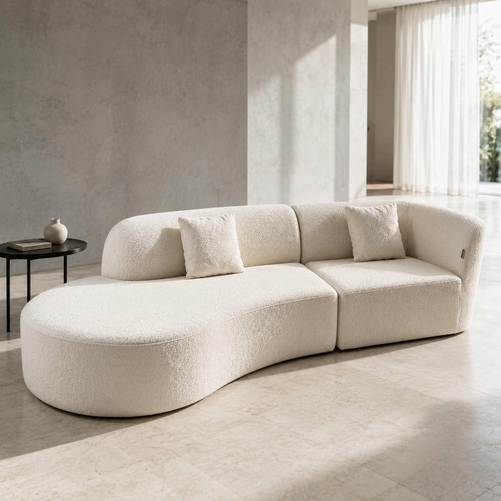 Lune Sofa in cream bouclé, the rounded chaise end sweeping into the seat
