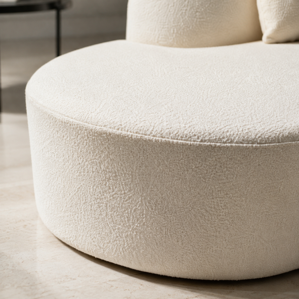 Close view of the Lune Sofa base, the continuous drum meeting the floor under the chaise