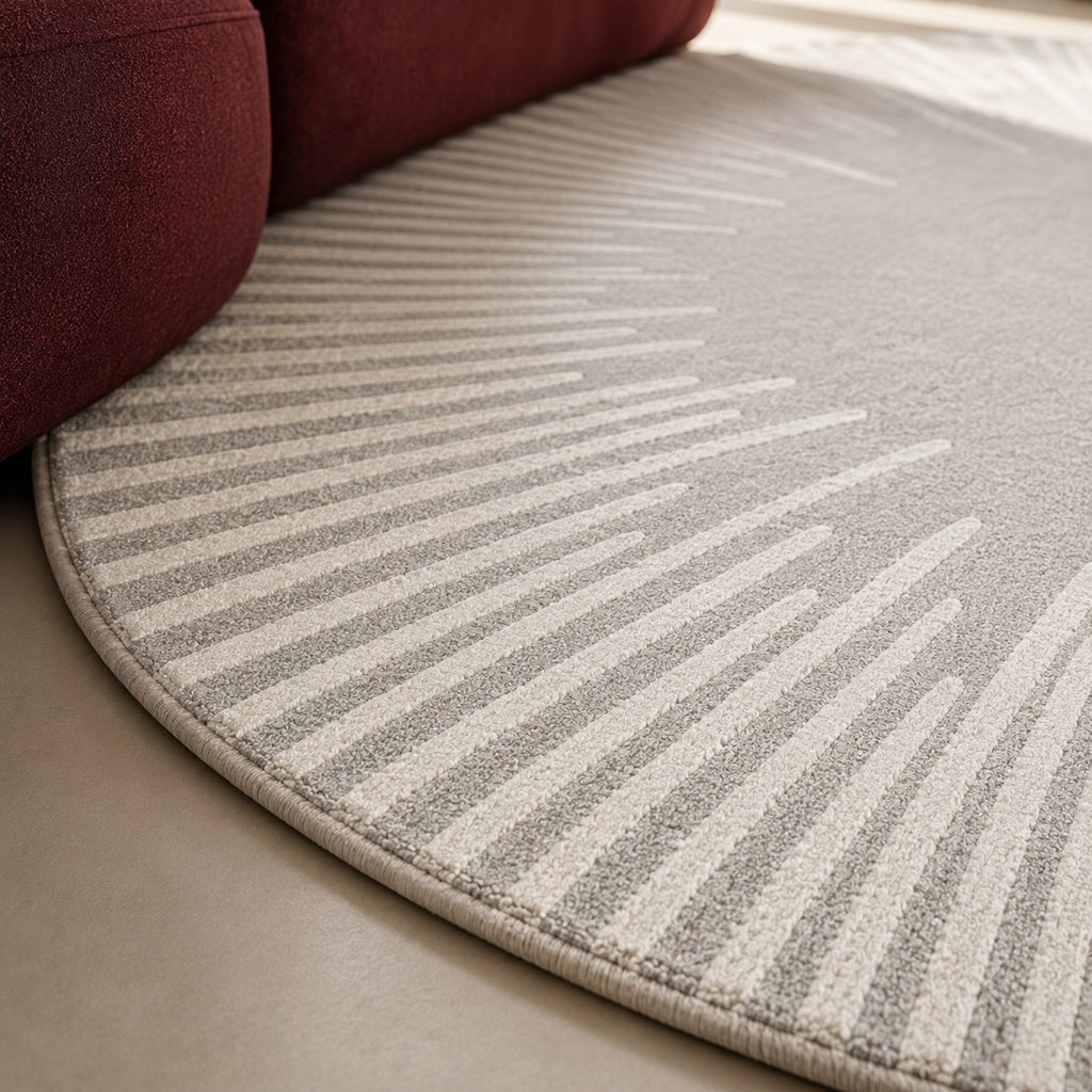 Close view of the Ondine Rug's bound round edge and the cut relief of the radiating lines