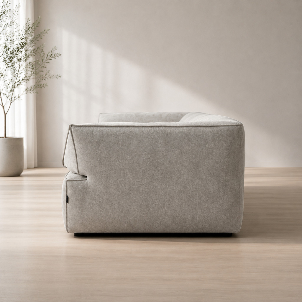 Pavé Sofa from the end, showing how low the block sits on its recessed plinth