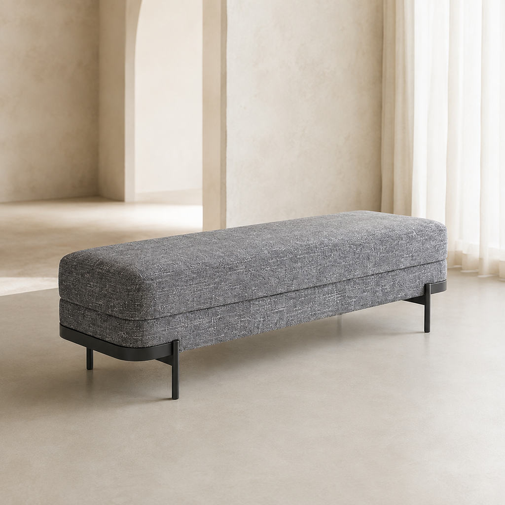 Perrin Bench in grey woven fabric on a black steel base, in a plastered room with an arched opening