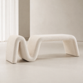 Ruban Bench in cream bouclé, one continuous folded band forming the seat, the fold and the legs