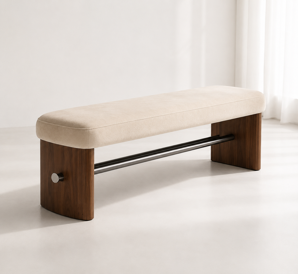 Tirant Bench with a cream pad on walnut side panels, joined by a black steel tie-rod with a brushed cap