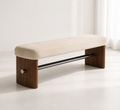 Tirant Bench with a cream pad on walnut side panels, joined by a black steel tie-rod with a brushed cap
