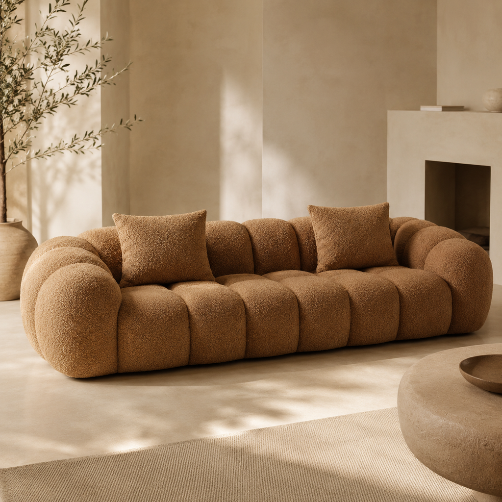 Tonneau Sofa at an angle beside a fireplace, the arms curling round to meet the back