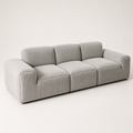 Triptyque Sofa in pearl corduroy seen at an angle, three modules between two wide low arms