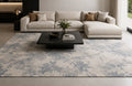 Valori Rug in grey and slate blue under a large ivory sofa and a black marble coffee table