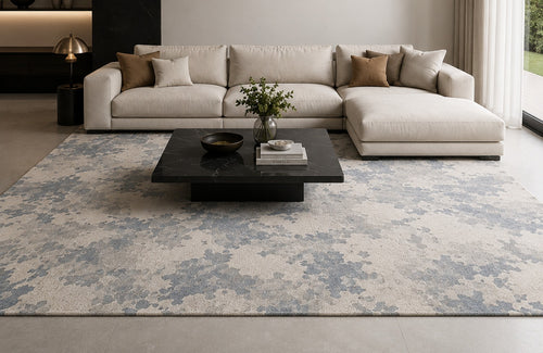 Valori Rug in grey and slate blue under a large ivory sofa and a black marble coffee table