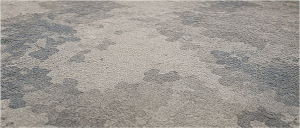 The mottled grey, slate blue and ivory surface of the Valori Rug seen up close
