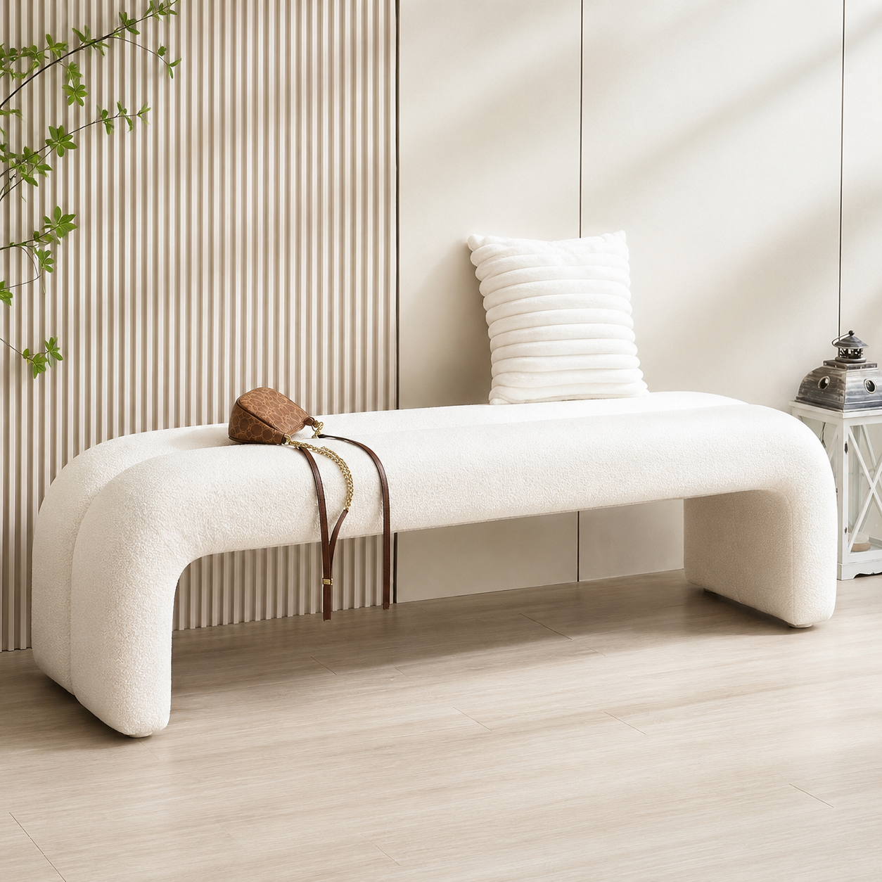 Voute Bench in an entrance hall with a slatted wall, a cushion at one end and a bag laid on the seat